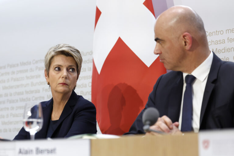 Swiss Finance Minister Karin Keller-Sutter, left, and Swiss Federal President Alain Berset discuss during a press conference, on Sunday, 19 March 2023 in Bern. Switzerland's largest bank UBS agreed to take over Credit Suisse for 3 billion Swiss francs ($3.25 billion) in a government-brokered deal over the weekend following days of market upheaval over the health of the banking sector.(KEYSTONE/Peter Klaunzer)