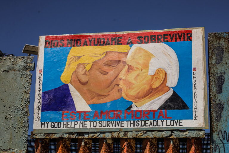 epa10549380 View of a painting of former US president Donald Trump kissing the current President, Joe Biden (R), at the border wall in the city of Tijuana in Baja California, Mexico, 28 March 2023 (issued 29 March 2023). A kiss between former US President Donald Trump and the current one, Joe Biden, is embodied in a painting on the border wall with which activists denounce immigration restrictions and the reconstruction of the fence that the United States is carrying out in the Binational Park of Friendship. It is a work by Mexican artists Chris Cuauhtli and Javier Salazar Rojas. EPA/Joebeth Terriquez