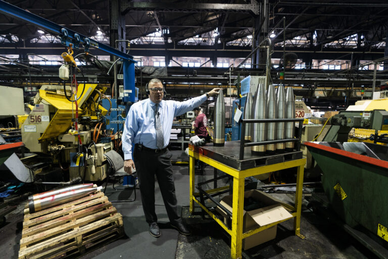 Richard Hansen, a Navy veteran who is the Army commander's representative at the Scranton Army Ammunition Plant with members of the media during a tour of the manufacturing process of 155 mm M795 artillery projectiles in Scranton, Pa., Thursday, April 13, 2023. One of the most important munitions of the Ukraine war comes from a historic factory in this city built by coal barons, where tons of steel rods are brought in by train to be forged into the artillery shells Kyiv can't get enough of — and that the U.S. can't produce fast enough. (AP Photo/Matt Rourke)