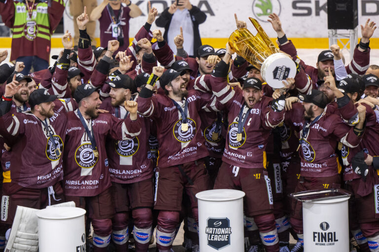Geneva's players celebrate with the trophy of Swiss Champion after winning by 4:1 the seventh and final leg of the ice hockey National League Swiss Championship final playoff game between Geneve-Servette HC and EHC Biel-Bienne at the ice stadium Les Vernets, in Geneva, Switzerland, Thursday, April 27, 2023. (KEYSTONE/Martial Trezzini)