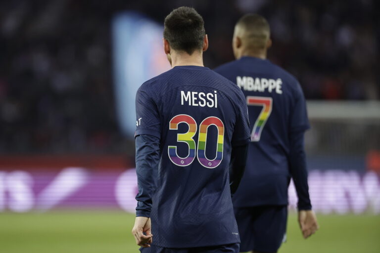 epa10626169 Paris Saint Germain's Lionel Messi (L) and Paris Saint Germain's Kylian Mbappe (R) wear a jersey in supporting LGBT community during the French Ligue 1 soccer match between PSG and AC Ajaccio at the Parc des Princes stadium in Paris, France, 13 May 2023. EPA/CHRISTOPHE PETIT TESSON