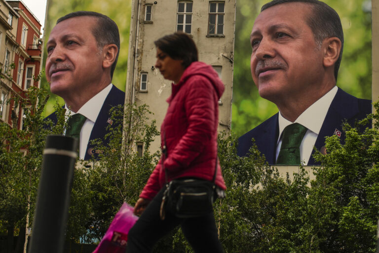 A person walks past billboards of Turkish President and People's Alliance's presidential candidate Recep Tayyip Erdogan a day after the presidential election day, in Istanbul, Turkey, Monday, May 15, 2023. Turkey's presidential elections appeared to be heading toward a second-round runoff on Monday, with President Recep Tayyip Erdogan, who has ruled his country with a firm grip for 20 years, leading over his chief challenger, but falling short of the votes needed for an outright win. (AP Photo/Emrah Gurel)