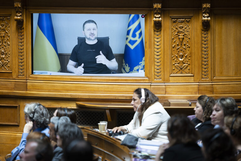 Ukrainian President Volodymyr Zelensky is displayed on a screen during his speech to the members of the Swiss parliament, in Bern, Switzerland, Thursday, June 15, 2023. (KEYSTONE/Peter Klaunzer)