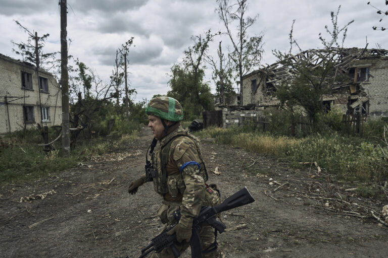 A Ukrainian soldier walks in recently retaken Blahodatne, Donetsk region, Ukraine, Friday, June 16, 2023. (AP Photo/Libkos)