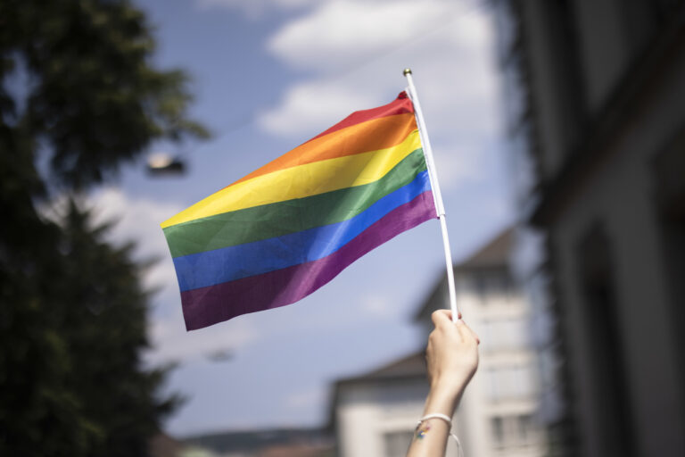 A person holds a rainbow flag during the Zurich Pride parade in Zurich, Switzerland, on Saturday, June 17, 2023. (KEYSTONE/Michael Buholzer)