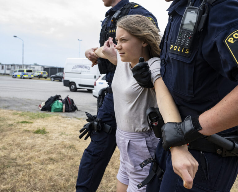 Police officers lead off the Swedish climate activist Greta Thunberg as they move activists from the organization 'Ta Tillbaka Framtiden' (Take back the future) who are blocking the entrance to the Oljehamnen neighbourhood in Malmo, Sweden, Monday, June 19, 2023. (Johan Nilsson/TT News Agency via AP)