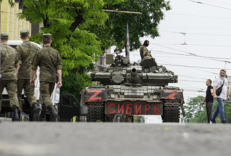 epa10709278 Servicemen from private military company (PMC) Wagner Group block a street with a tank reading 'Siberia' in downtown Rostov-on-Don, southern Russia, 24 June 2023. Security and armoured vehicles were deployed after Wagner Group's chief Yevgeny Prigozhin said in a video that his troops had occupied the building of the headquarters of the Southern Military District, demanding a meeting with RussiaâÄ™s defense chiefs. EPA/STRINGER