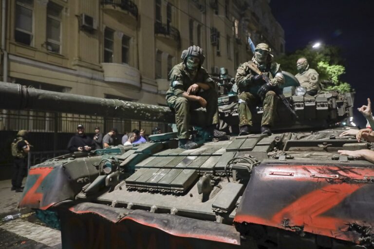 FILE - Membes of the Wagner Group military company sit atop of a tank on a street in Rostov-on-Don, Russia, Saturday, June 24, 2023, prior to leaving an area at the headquarters of the Southern Military District. (AP Photo, File)