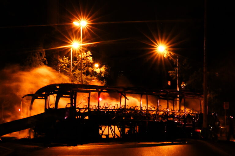 epa10720118 Firefighters extinguish a bus burned during clashes between protesters and riot police in Nanterre, near Paris, France, 30 June 2023. Violence broke out all over France after police fatally shot a 17-year-old teenager during a traffic stop in Nanterre on 27 June. EPA/MOHAMMED BADRA