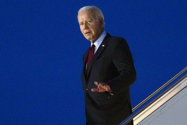 President Joe Biden waves as he walks down the steps of Air Force One at Stansted Airport in Stansted, England, Sunday, July 9, 2023. (AP Photo/Susan Walsh)