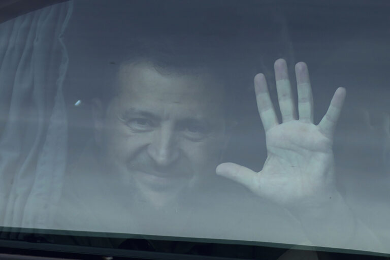 Ukraine's President Volodymyr Zelenskyy waves from his car as he leaves the NATO summit in Vilnius, Lithuania, Wednesday, July 12, 2023. The United States and other major industrialized nations are pledging long-term security assistance for Ukraine as it continues to fight Russia's invasion. (AP Photo/Pavel Golovkin)