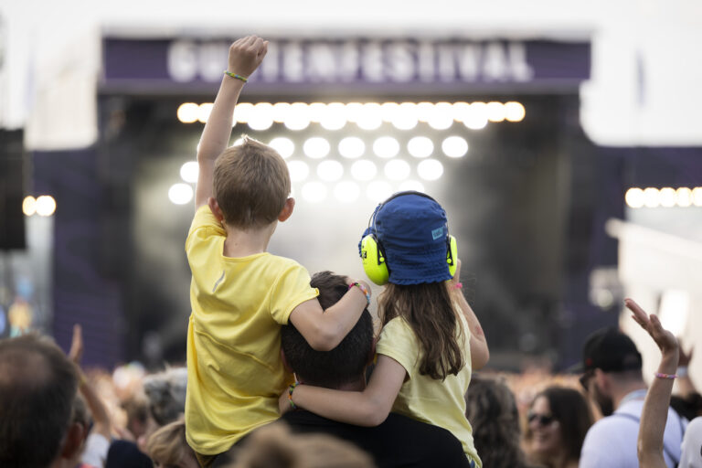 Two young festival goers enjoy a concert front of the main stage at the 40th Gurtenfestival edition, in Bern, Switzerland, on Sunday, July 16, 2023. The open air music festival runs from 12 to 16 July. (KEYSTONE/Anthony Anex)