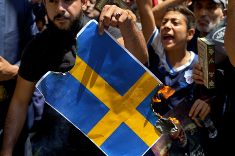 Hezbollah supporters chant slogans as they burn representations of the Swedish flag during a rally denouncing the desecration of the Quran after Friday prayers in the southern Beirut suburb of Dahiyeh, Lebanon, Friday, July 21, 2023. Muslim-majority nations expressed outrage Friday at the desecration of the Islamic holy book in Sweden. Following midday prayers, thousands took to the streets to show their anger, in some cases answering the call of religious and political leaders. (AP Photo/Bilal Hussein)