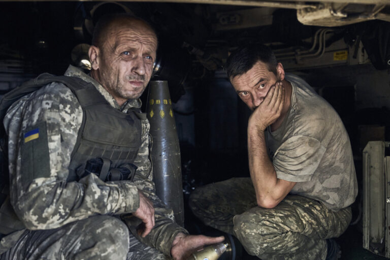 Ukrainian soldiers sit inside self-propelled howitzer at the front line in Donetsk region, Ukraine, Wednesday, Aug. 9, 2023. (AP Photo/Libkos)