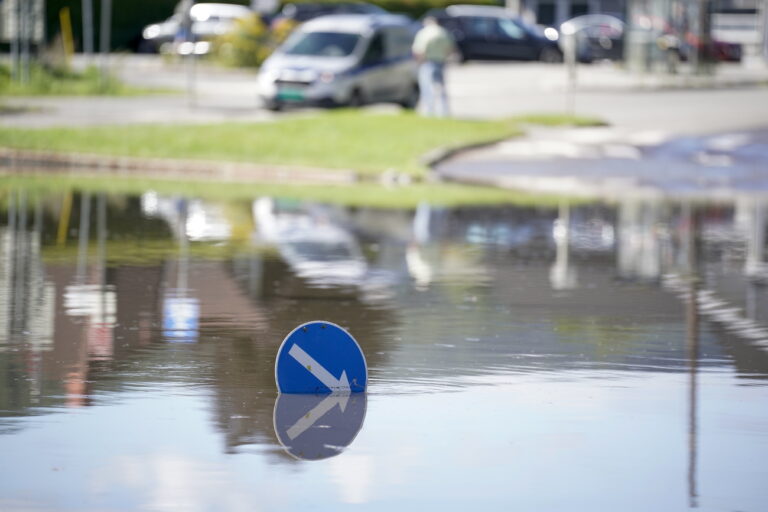 epa10794721 Roads are flooded in Mjondalen, Norway, 11 August 2023. Several areas were affected by the storm Hans that hit south-east Norway with floods and landslides following heavy rains. EPA/STIAN LYSBERG SOLUM NORWAY OUT