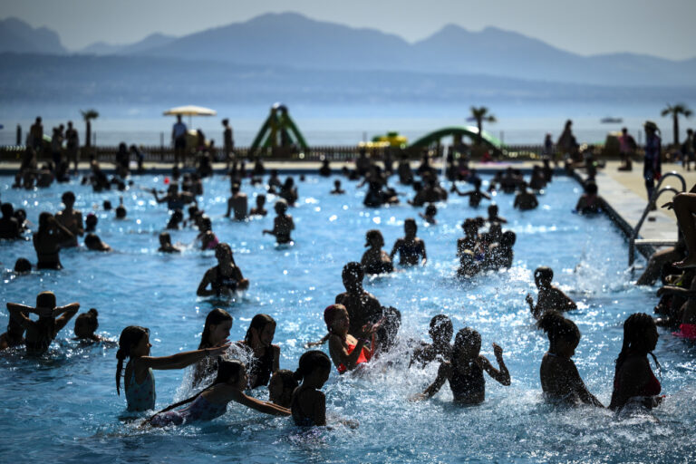 People cool off in the water during hot weather at the public swimming pool Bellerive on the shore of the Geneva Lake, in Lausanne, Switzerland, Wednesday, August 23, 2023. The city of Lausanne has decided to open its swimming pools free of charge as many parts of Switzerland have been experiencing a period of extreme heat. A heat dome has been hovering over the country for an indefinite period since Friday. (KEYSTONE/Laurent Gillieron)