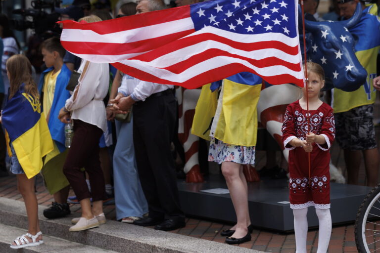 epa10818869 Melania Popov, wearing traditional Ukrainian clothing, holds an American Flag as she and others celebrate the National Day of Ukraine during an event at Millennium Park, in Boston, Massachusetts, USA, 24 August 2023. Ukrainian Independence Day is celebrated on 24 August to mark Ukraine's independence from the Soviet Union in 1991. EPA/CJ GUNTHER