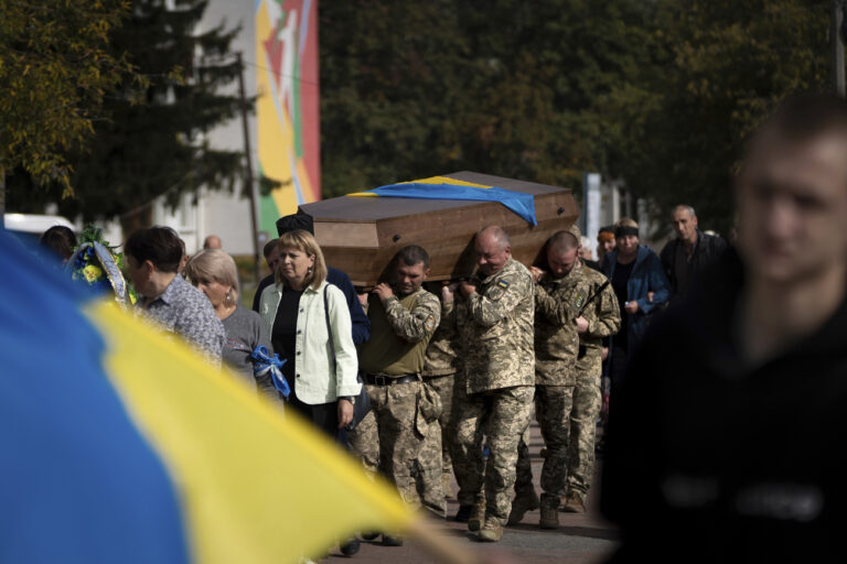 Ukrainian soldiers carry the coffin of their comrade Andrii 
