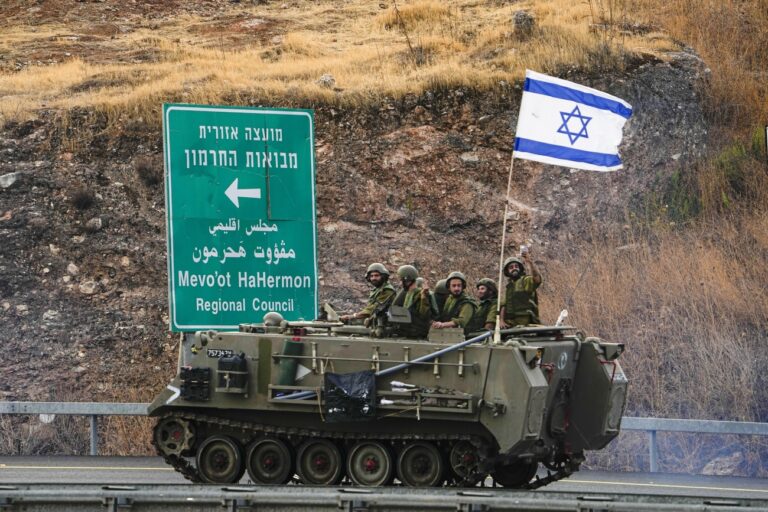 Israeli soldiers drive an armored personal carrier near the border with Lebanon, Wednesday, Oct. 11, 2023. Lebanon's state-run National News Agency says Israeli shelling of southern Lebanese villages has wounded three civilians and damaged about 10 homes. The agency said the shelling hit the villages of Marwaheen and Duhaira. The Israeli shelling came after the militant Hezbollah fired an anti-tank missile at an Israeli army position. (AP Photo/Ariel Schalit)