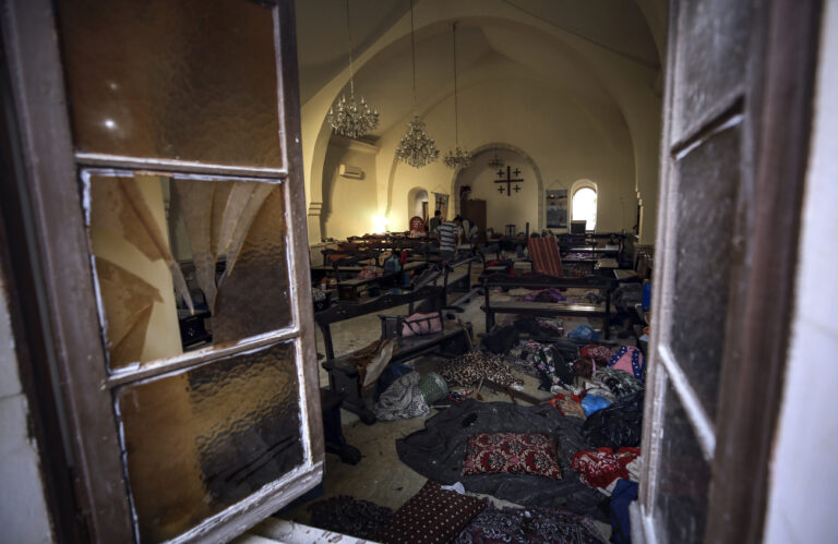 Palestinians inspect the damage in a church people were using as a shelter, at al-Ahli hospital, in Gaza City, Wednesday, Oct. 18, 2023. The Hamas-run Health Ministry says an Israeli airstrike caused the explosion that killed hundreds at al-Ahli, but the Israeli military says it was a misfired Palestinian rocket. (AP Photo/Abed Khaled)