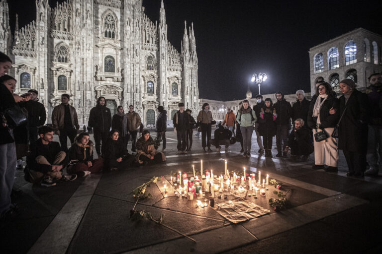People attend a candlelight vigil in front of the Milan Duomo Cathedral for 22-year-old Giulia Cecchettin, northern Italy, Sunday, Nov. 19, 2023. Her body, reportedly with multiple stab wounds, was found wrapped in plastic on Saturday in a ditch near Venice. Police in Germany over the weekend arrested Filippo Turetta, 21, who had been on the run since Nov. 11, when he was last seen arguing with Giulia Cecchettin. (Marco Ottico/LaPresse via AP)
