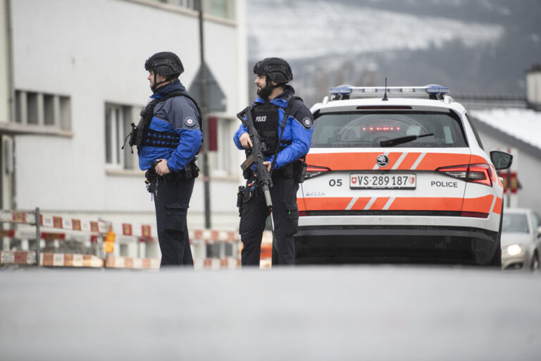 The Police is standing on a closed road in Sion, Switzerland, Monday, December 11, 2023. According to the police of the canton of Valais. An individual fired several shots in Sion on Monday morning, at two separate locations. Two people died and another was injured. An individual fired several shots in Sion on Monday morning, at two separate locations. Two people died and another was injured. (KEYSTONE/Louis Dasselborne)