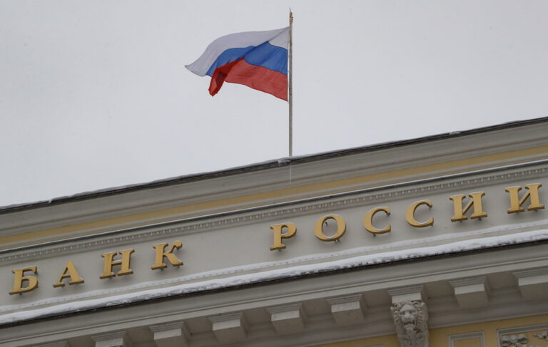 epa11030638 Russian National flag waves above the sign reading 'Bank of Russia' on the Russia's Central Bank headquarter building in Moscow, Russia, 15 December 2023. The Board of Directors of the Bank of Russia decided to increase the key rate by 100 basis points (bp) to 16.0 percent per annum, noting that current inflation pressure remains high. The Bank of Russia expects GDP growth in 2023 to outperform its October forecast and exceed 3 percent. EPA/MAXIM SHIPENKOV