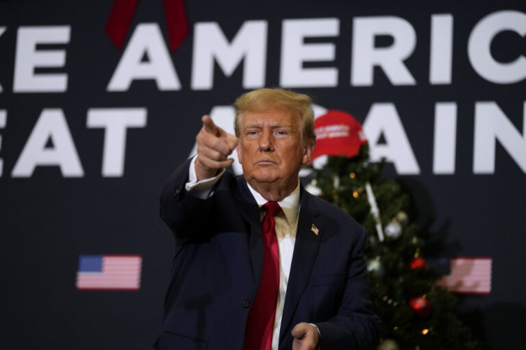 Former President Donald Trump reacts to supporters during a commit to caucus rally, Tuesday, Dec. 19, 2023, in Waterloo, Iowa. (AP Photo/Charlie Neibergall)