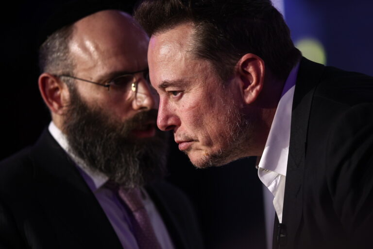 epa11096697 US tech entrepreneur Elon Musk (R) and EJA Chairman Rabbi Menachem Margolin (L) talk to each other during a symposium on anti-Semitism titled 'Never again: Lip Service or Deep Commitment', as part of an event organized by the European Jewish Association EJA in Krakow, Poland, 22 January 2024. EPA/Lukasz Gagulski POLAND OUT