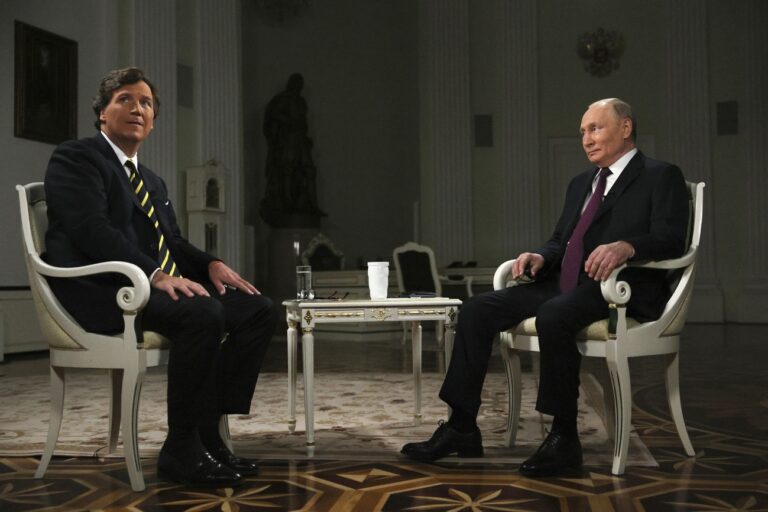 In this photo released by Sputnik news agency on Friday, Feb. 9, 2024, Russian President Vladimir Putin, right, and former Fox News host Tucker Carlson prepare to an interview at the Kremlin in Moscow, Russia, Tuesday, Feb. 6, 2024. (Gavriil Grigorov, Sputnik, Kremlin Pool Photo via AP)