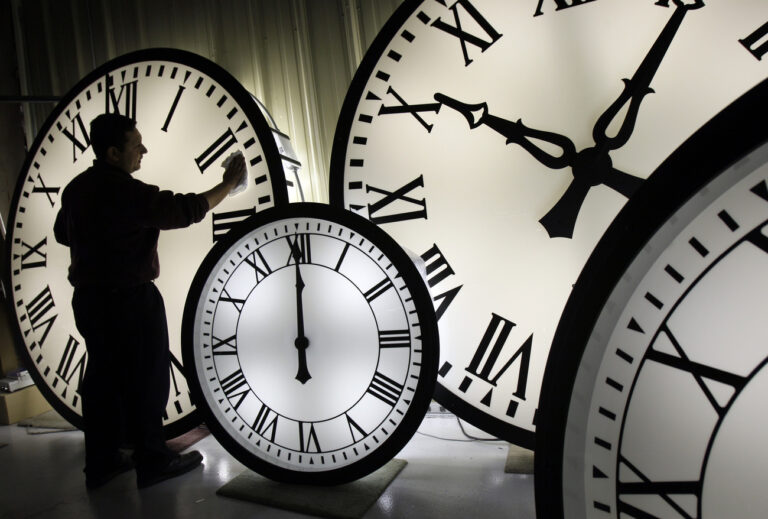 Electric Time Co. employee Walter Rodriguez cleans the face of an 84-inch Wegman clock at the plant in Medfield, Mass. Thursday, Oct. 30, 2008. Once again, most Americans will set their clocks forward by one hour this weekend, losing perhaps a bit of sleep but gaining more glorious sunlight in the evenings as the days warm into summer. There's been plenty of debate over the practice but about 70 countries 