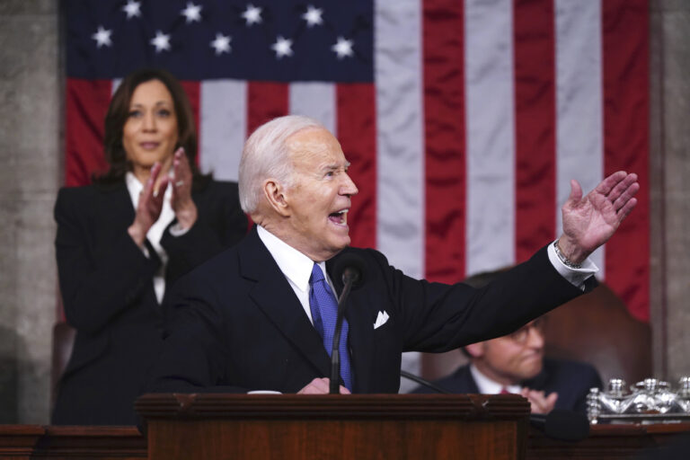 President Joe Biden delivers the State of the Union address to a joint session of Congress at the Capitol, Thursday, March 7, 2024, in Washington. Standing at left is Vice President Kamala Harris and seated at right is House Speaker Mike Johnson, R-La. (Shawn Thew/Pool via AP)