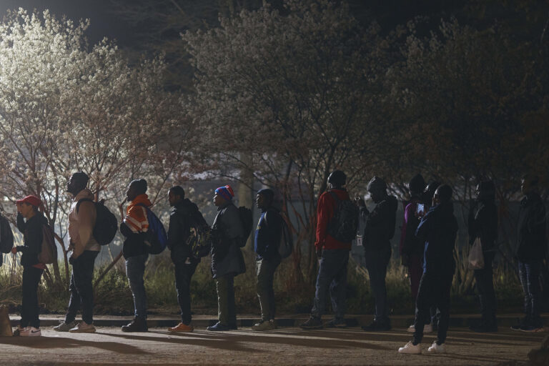 Migrants queue to enter the migrant shelter on Randall's Island, on Tuesday, April 9, 2024, in New York. (AP Photo/Andres Kudacki)