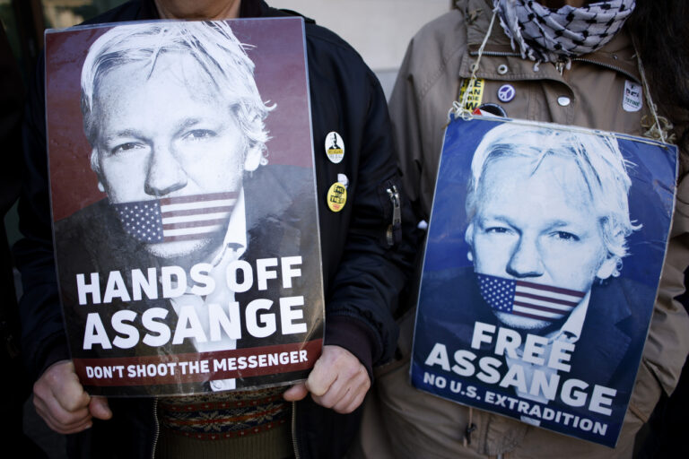 Activists marking five years since the arrest of Wikileaks founder Julian Assange demonstrate outside Westminster Magistrates' Court in London, Sunday, April 14, 2024. U.S. President Joe Biden said last week that he is considering a request from Australia to drop the decade-long U.S. push to prosecute Assange for publishing a trove of American classified documents. Assange is currently fighting extradition to the U.S. from Belmarsh Prison in London. (AP Photo/David Cliff)