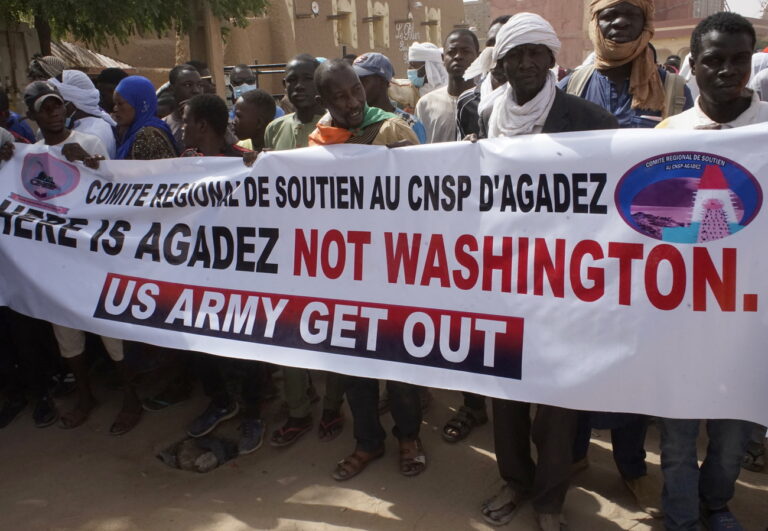 epa11291927 Demonstrators hold a banner during a protest rally to demand the withdrawal of US troops from Niger, in Agadez, Niger, 21 April 2024. In March 2024, the ruling military junta revoked a military agreement with the US. Niger's decision to oust the US military out of the country follows France's withdrawal of its forces from Niger last year. EPA/ISSIFOU DJIBO