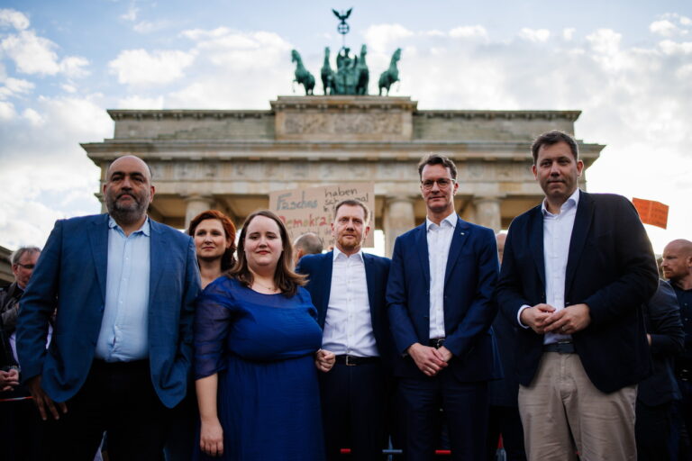 epa11320428 Green party (Die Gruenen) co-chair Omid Nouripour (L), Green party (Die Gruenen) co-chair Ricarda Lang (3-L), Saxony State Premier Michael Kretschmer (4-L), North Rhine-Westphalia State Premier Hendrik Wuest (5-L) and Social Democratic Party (SPD) co-chairman Lars Klingbeil (R) pose for the media as they stand next to each other in front of the Brandenburg Gate during a rally in reaction to attacks on campaigning politicians in Germany, in Berlin, Germany, 05 May 2024. The rally was held after Saxony Social Democratic Party's (SPD) top candidate for the upcoming European elections and Member of the European Parliament, Matthias Ecke, was attacked by a small group of people, on 03 May 2024, during the process of installing campaign posters. EPA/CLEMENS BILAN
