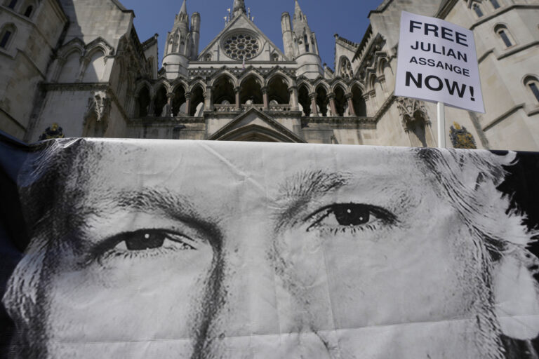 A poster of Julian Assange is left by protesters outside the High Court in London, Monday, May 20, 2024. A British court has ruled that WikiLeaks founder Julian Assange can appeal against an order that he be extradited to the U.S. on espionage charges.(AP Photo/Kin Cheung)