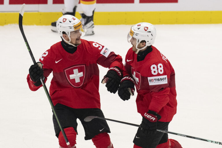 Switzerland's Gaetan Haas, left, and Switzerland's Christoph Bertschy icelebrate their goal to 1-0 during the Ice Hockey World Championship quarter final match between Switzerland and Germany in Ostrava at the Ostravar Arena, Czech Republic, on Thursday, May 23, 2024. (KEYSTONE/Peter Schneider)