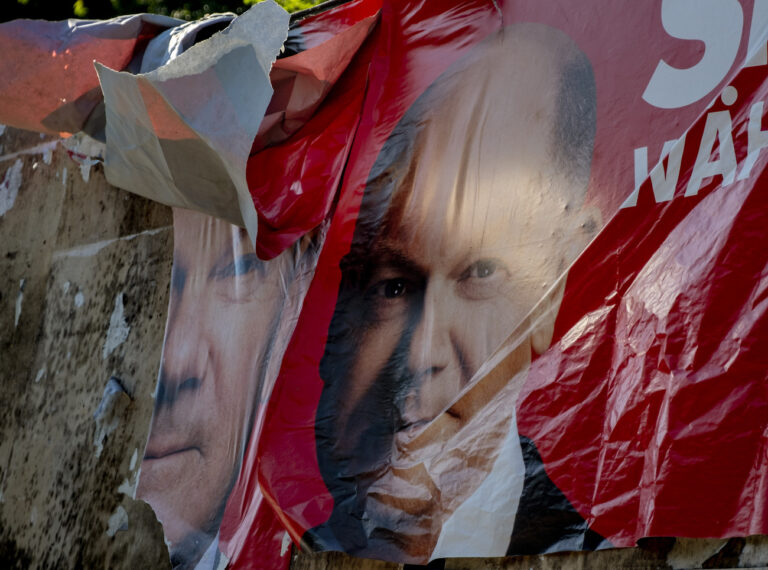 A damaged election poster shows German Chancellor Olaf Scholz in Frankfurt, Germany, Sunday, June 9, 2024. (AP Photo/Michael Probst)