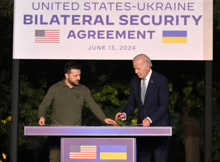 epa11408542 US President Joe Biden (R) and Ukrainian President Volodymyr Zelensky (L) sign a security agreement after a bilateral meeting on the sidelines of the G7 summit in Savelletri (Brindisi), Italy, 13 June 2024. The 50th G7 summit will bring together the Group of Seven member states leaders in Borgo Egnazia resort in southern Italy from 13 to 15 June 2024. EPA/ETTORE FERRARI
