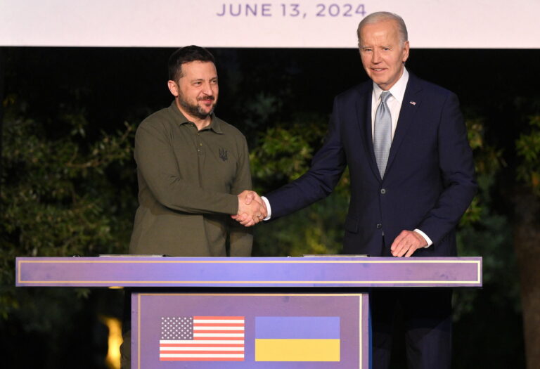 epa11408547 US President Joe Biden (R) and Ukrainian President Volodymyr Zelensky (L) shake hands after they sign a security agreement after a bilateral meeting on the sidelines of the G7 summit in Savelletri (Brindisi), Italy, 13 June 2024. The 50th G7 summit will bring together the Group of Seven member states leaders in Borgo Egnazia resort in southern Italy from 13 to 15 June 2024. EPA/ETTORE FERRARI