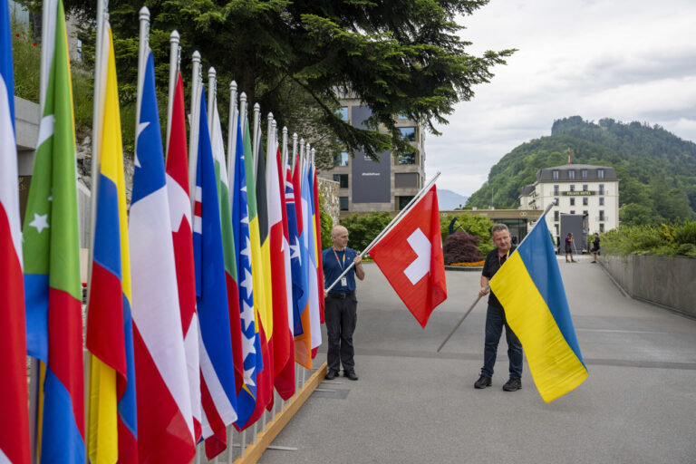 Bernhard, left, and Daniel Egger, right, places the flag of Switzerland during the final preparations ahead the Summit on peace in Ukraine, in Stansstad near Lucerne, Switzerland, Friday, June 13, 2024. Heads of state from around the world gather on the Buergenstock Resort in central Switzerland for the Summit on Peace in Ukraine, on June 15 and 16. (KEYSTONE/EDA/POOL/Urs Flueeler)