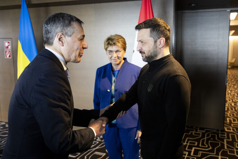 Swiss Federal Councillor Ignazio Cassis, left, and Ukrainian President Volodymyr Zelenskyy, right, shake hands front of the Swiss Federal President Viola Amherd during the Summit on peace in Ukraine, in Stansstad near Lucerne, Switzerland, Saturday, June 15, 2024. Heads of state from around the world gather on the Buergenstock Resort in central Switzerland for the Summit on Peace in Ukraine, on June 15 and 16. (KEYSTONE/EDA/POOL/Michael Buholzer)