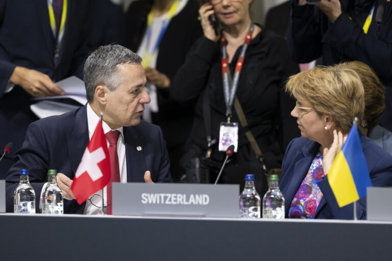 Swiss Federal Councillor Ignazio Cassis, left, speaks with Swiss Federal President Viola Amherd, right, during the plenary session, during the Summit on peace in Ukraine, in Stansstad near Lucerne, Switzerland, Sunday, June 16, 2024. Heads of state from around the world gather on the Buergenstock Resort in central Switzerland for the Summit on Peace in Ukraine, on June 15 and 16. (KEYSTONE/EDA/POOL/Urs Flueeler)