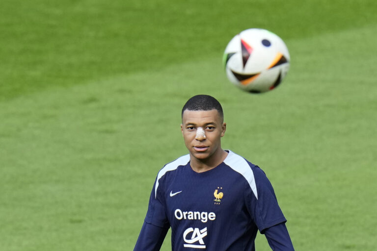 France's Kylian Mbappe eyes the ball during a training session in Paderborn, Germany, Wednesday, June 19, 2024. France will play against Netherland during their Group D soccer match at the Euro 2024 soccer tournament on June 21. (AP Photo/Hassan Ammar)