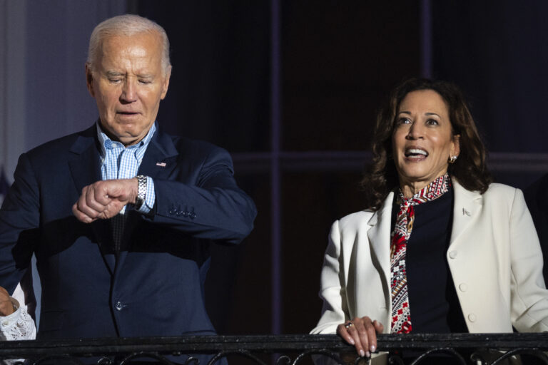 President Joe Biden and Vice President Kamala Harris wait for the start of the Independence Day firework display over the National Mall from the balcony of the White House, Thursday, July 4, 2024, in Washington. (AP Photo/Evan Vucci)