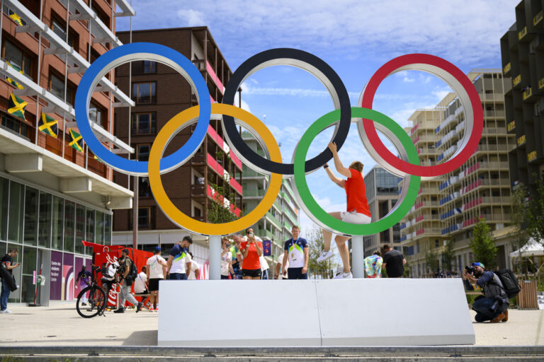 Athletes pose with the Olympic Rings during a media tour of the Olympic village of the 2024 Paris Summer Olympics in Paris, France, Thursday, July 25, 2024. (KEYSTONE/Laurent Gillieron)