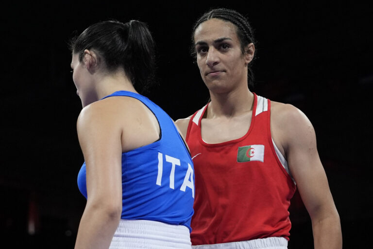 Algeria's Imane Khelif, right, walks beside Italy's Angela Carini after their women's 66kg preliminary boxing match at the 2024 Summer Olympics, Thursday, Aug. 1, 2024, in Paris, France. (AP Photo/John Locher)