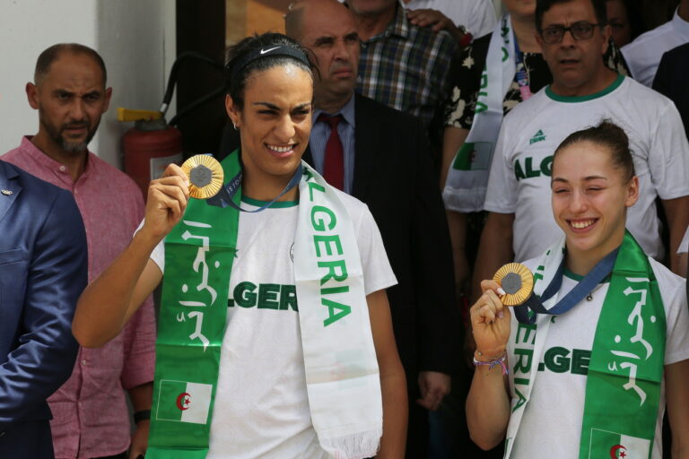 epa11546798 Paris Olympics Gold medal winner in the Women's 66kg Boxing competition Imane Khelif (L) and Gold medal winner in the Women's Uneven Bars competition Kaylia Nemour (R) pose with their medals upon their arrival at the International Airport in Algiers, Algeria, 12 August 2024. Algeria participated with 46 athletes (27 men, 19 women) in the Paris 2024 Olympic Games, competing in 15 disciplines. They achieved three medals, including two gold and one bronze. EPA/STRINGER