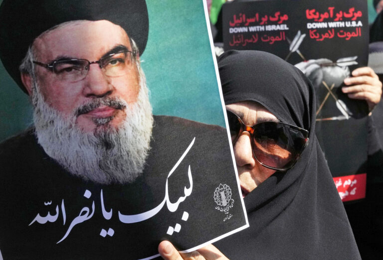 An Iranian worshipper holds up a poster of Hezbollah leader Sayyed Hassan Nasrallah, reading in Arabic: 